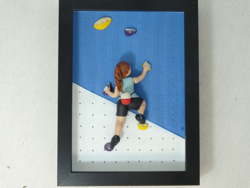 Figura de escalador enmarcado
